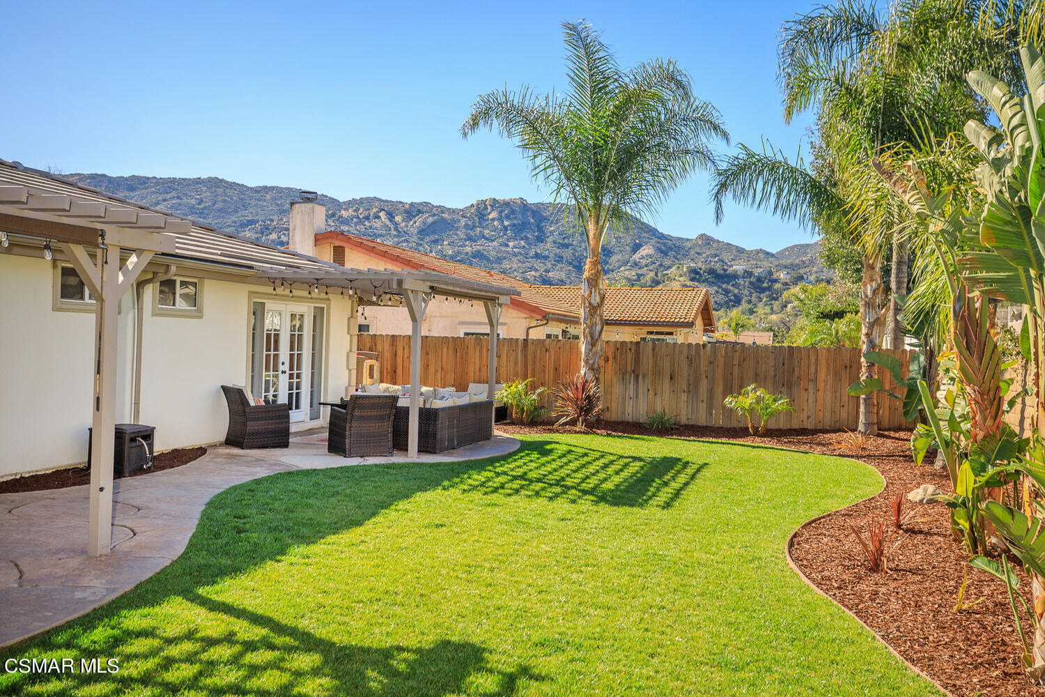 1871 Edgewood Drive Simi Valley, CA 93063 - Photo 2 of 26 a view of a backyard with table and chairs potted plants and large tree