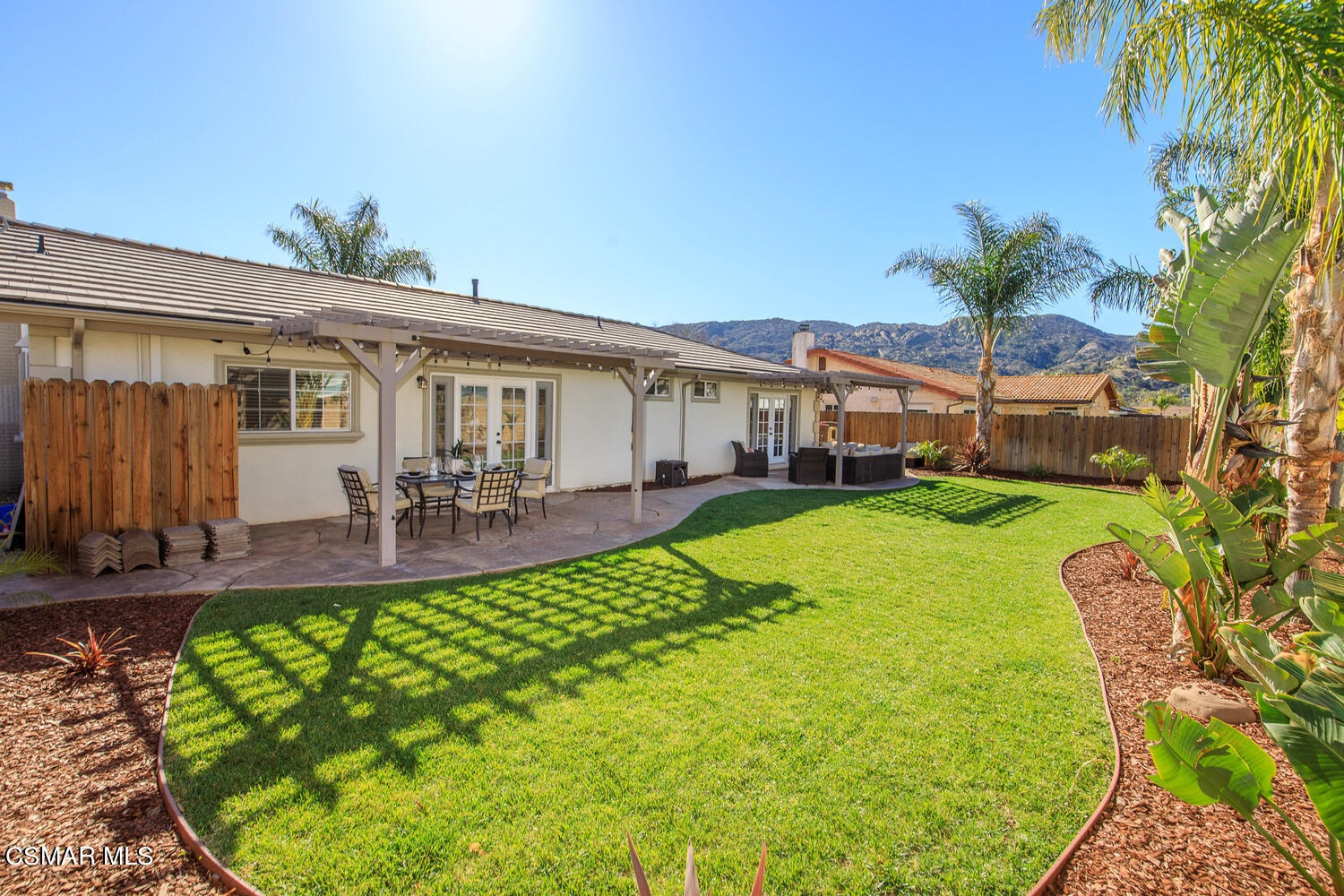1871 Edgewood Drive Simi Valley, CA 93063 - Photo 24 of 26 a view of a patio with table and chairs potted plants and large tree