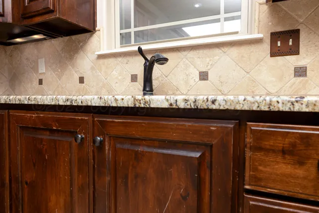 a view of kitchen with stainless steel appliances granite countertop a refrigerator and a sink