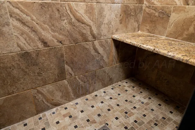 a bathroom with a granite countertop shower mirror and a sink