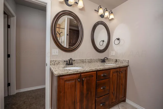an empty room with closet and a chandelier fan