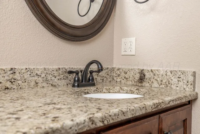 an empty room with chandelier fan