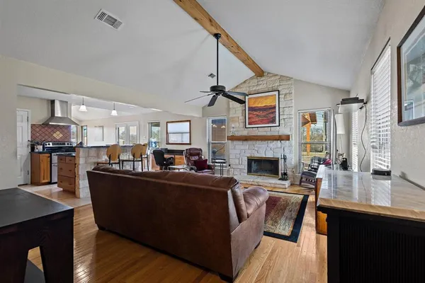 a living room with fireplace furniture and a fireplace