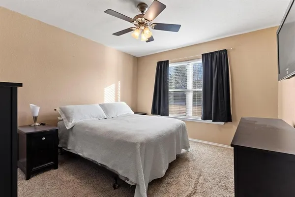 a bedroom with a bed and a large window