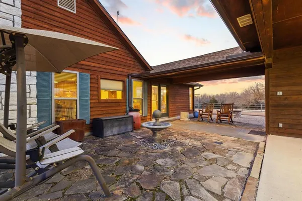 a building outdoor space with patio furniture and garden