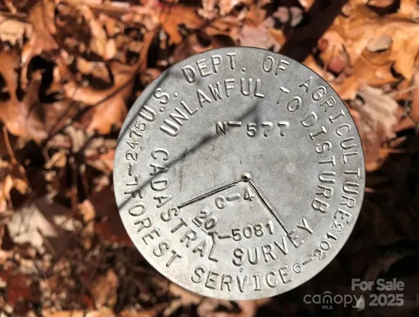 a view of a wooden fence next to a yard