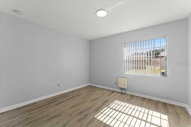 wooden floor in an empty room with a window