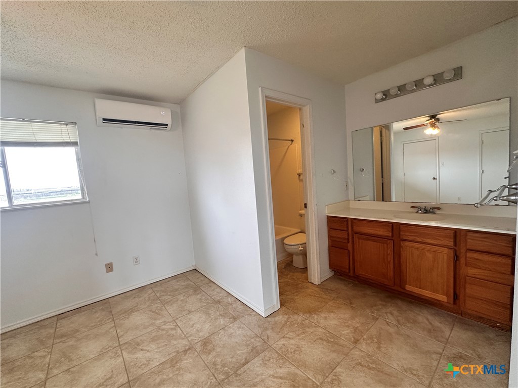 158 Stockmen Lane Maxwell, TX 78656 - Photo 17 of 20 a spacious bathroom with a granite countertop sink and a mirror