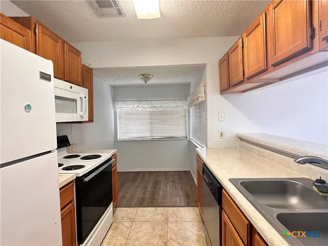a kitchen that has a sink and a stove