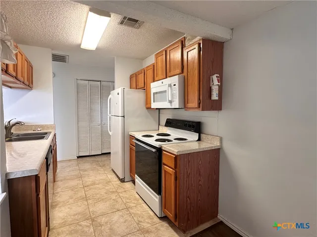 a kitchen with a stove and a refrigerator