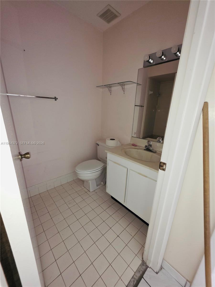 725 Northwest 123rd Avenue Miami, FL 33182 - Photo 13 of 18 a bathroom with a sink toilet and mirror