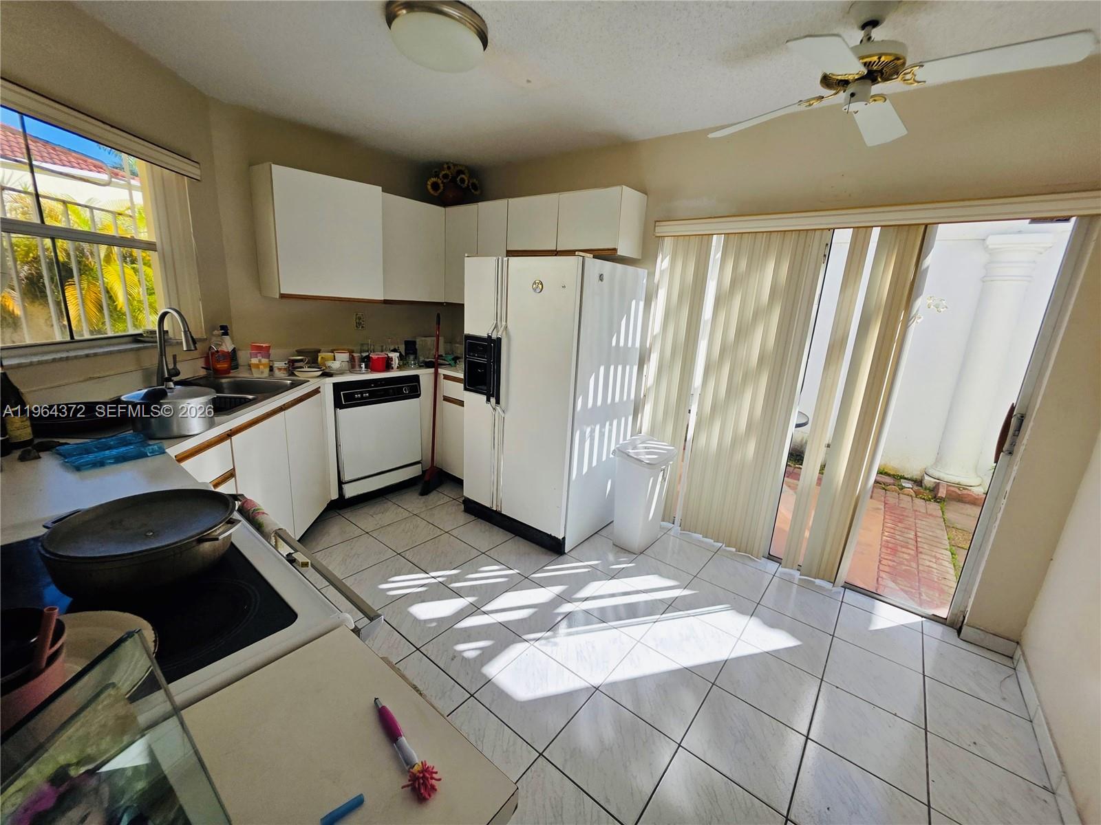 725 Northwest 123rd Avenue Miami, FL 33182 - Photo 15 of 18 a kitchen with a refrigerator and a stove