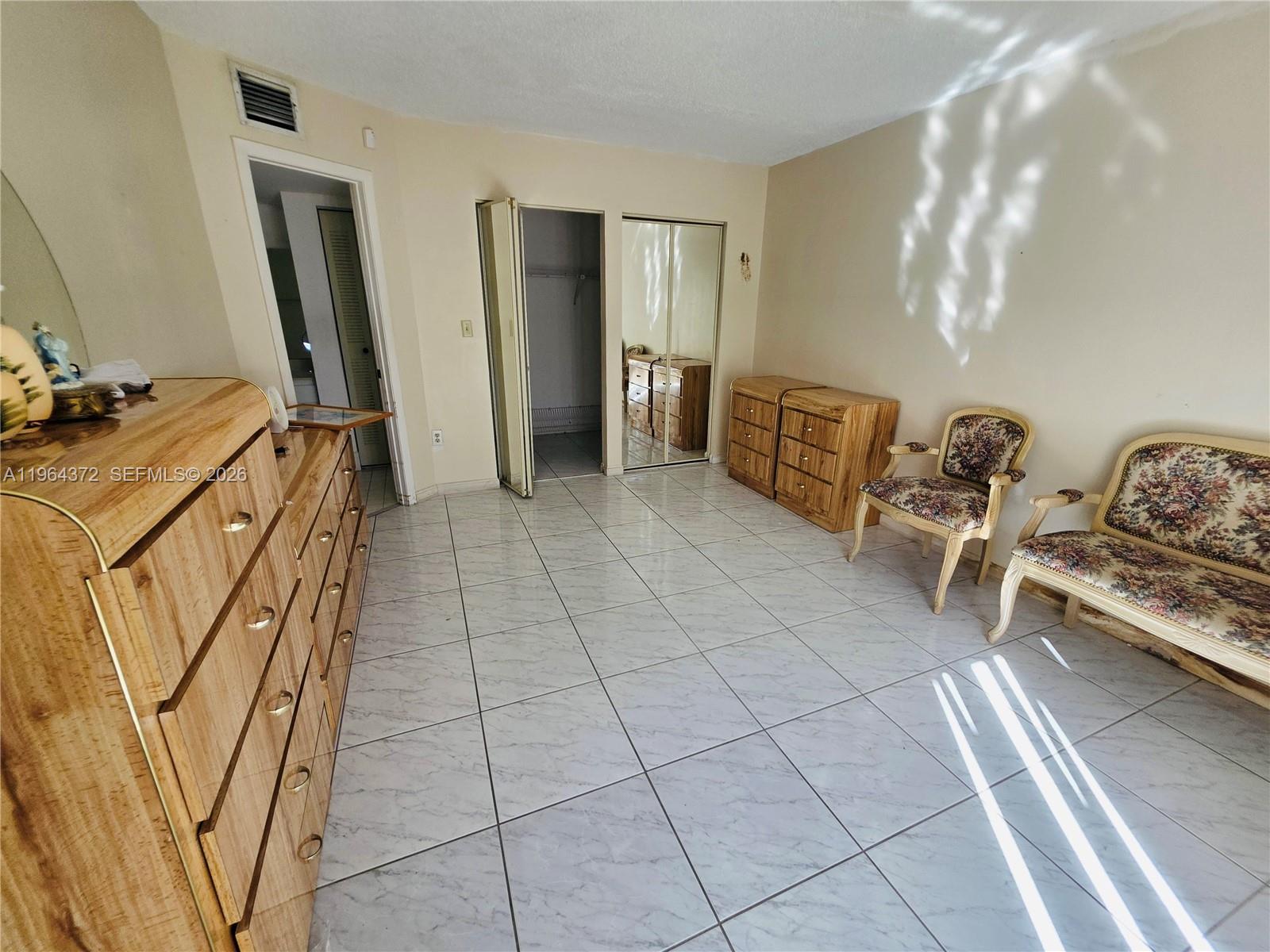 725 Northwest 123rd Avenue Miami, FL 33182 - Photo 6 of 18 a room with gym equipment and large mirror