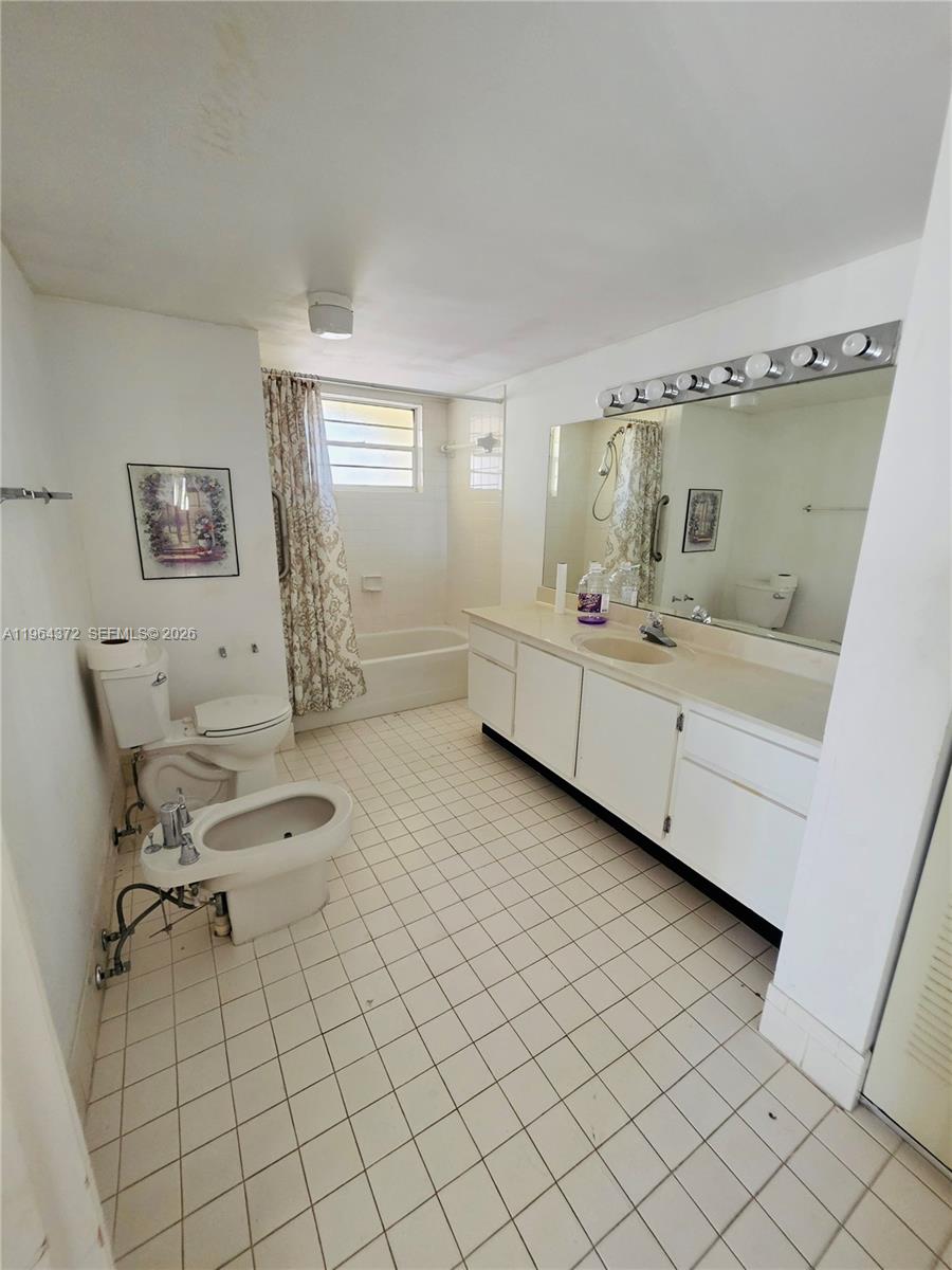 725 Northwest 123rd Avenue Miami, FL 33182 - Photo 7 of 18 a bathroom with a sink mirror and toilet