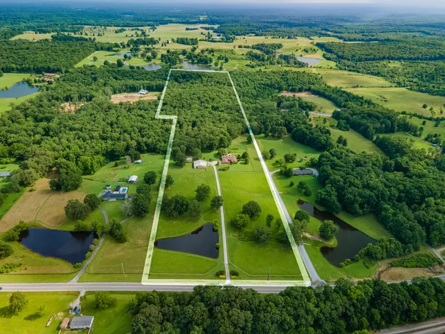 an aerial view of a house with yard swimming pool and outdoor seating