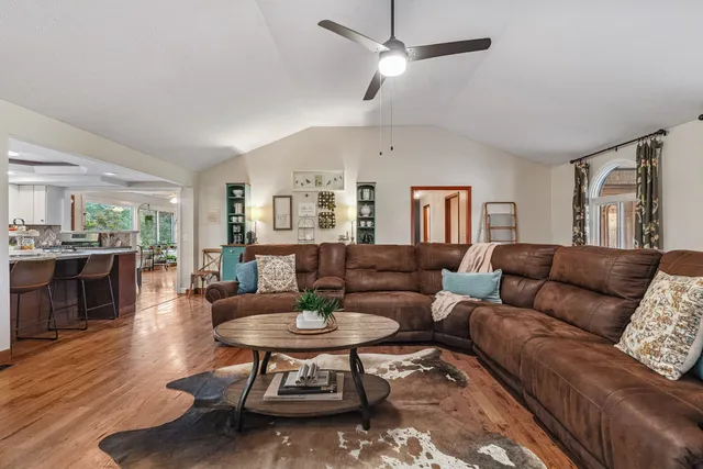 a living room with furniture a rug and a wall painting