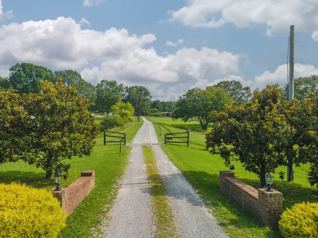 an aerial view of a residential houses with outdoor space and street view