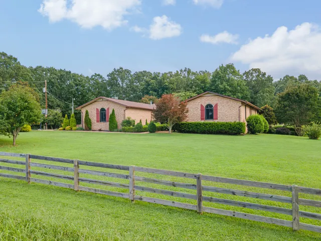 a kitchen with granite countertop stainless steel appliances cabinets a sink and a large window
