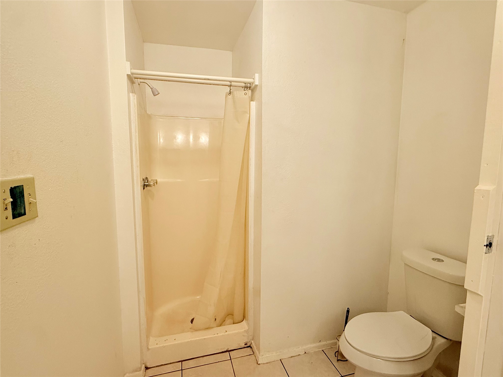 10618 Leitrim Way Houston, TX 77047 - Photo 11 of 13 a bathroom with a toilet and shower