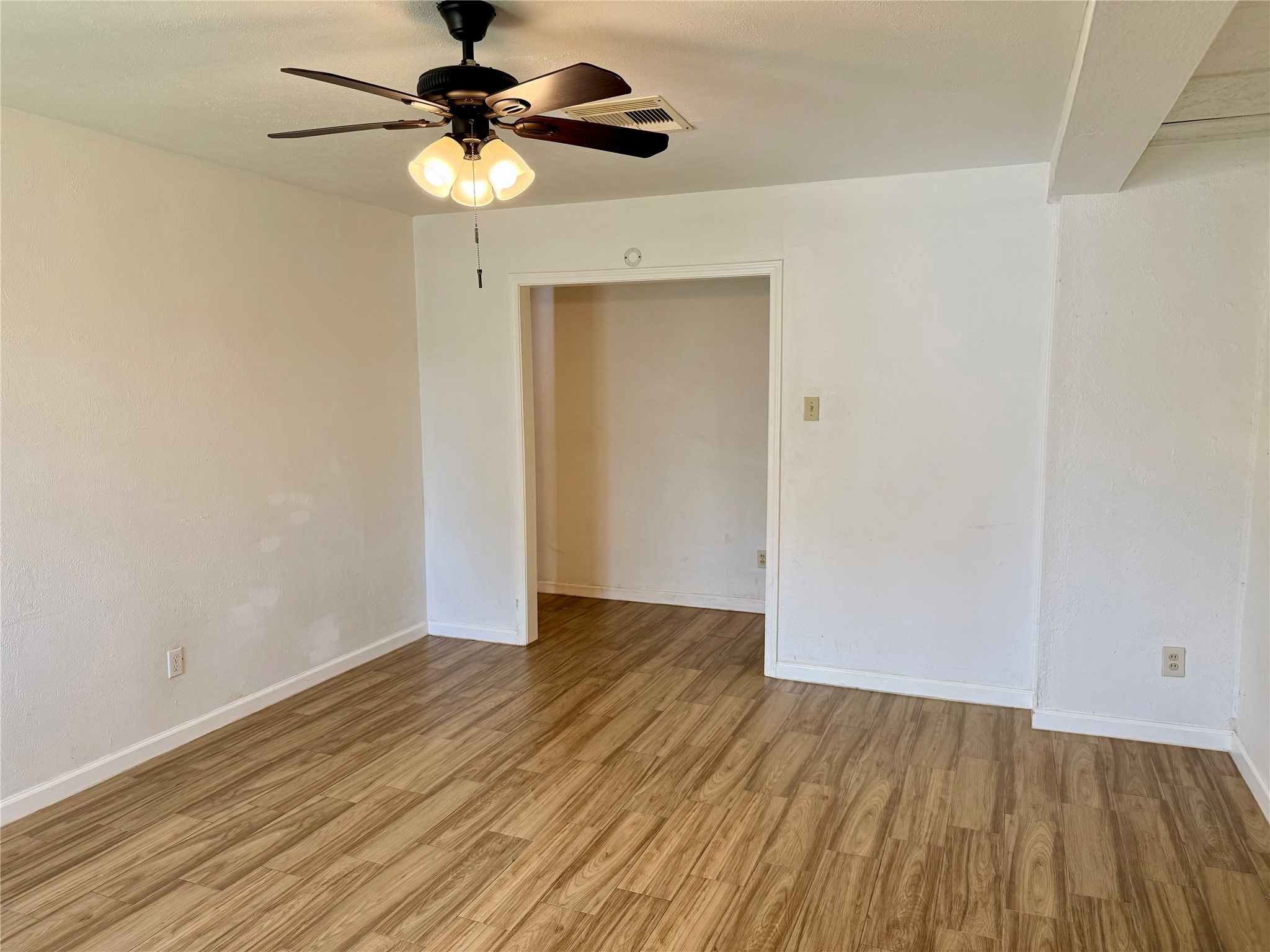 10618 Leitrim Way Houston, TX 77047 - Photo 2 of 13 a view of an empty room with wooden floor