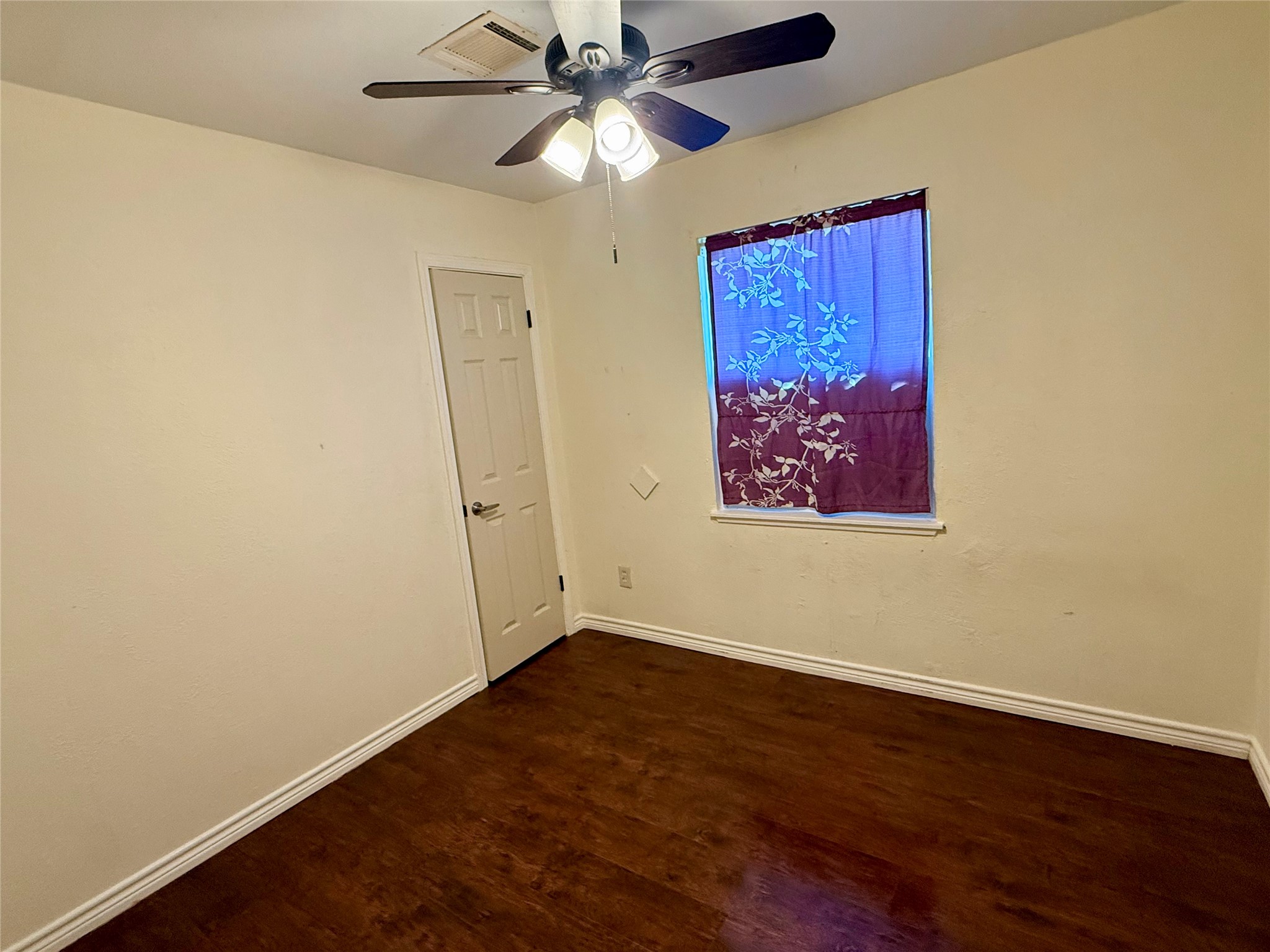 10618 Leitrim Way Houston, TX 77047 - Photo 8 of 13 an empty room with wooden floor ceiling fan and a ceiling fan