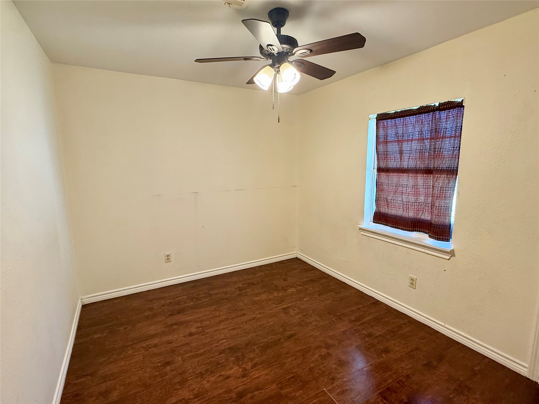10618 Leitrim Way Houston, TX 77047 - Photo 9 of 13 an empty room with a window and a ceiling fan