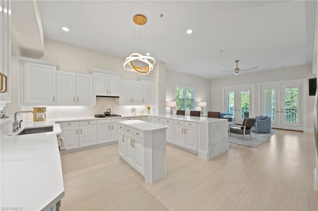 2886 Castillo Court, Unit 103 Naples, FL 34109 - Photo 1 of 38 a kitchen with a sink cabinets and window