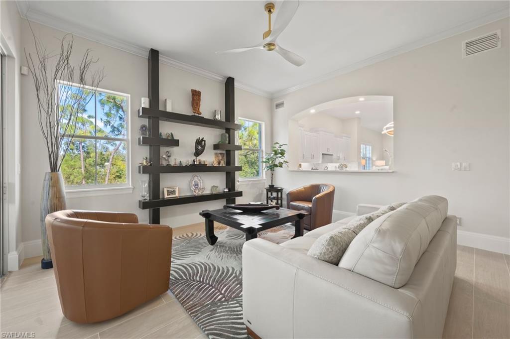 2886 Castillo Court, Unit 103 Naples, FL 34109 - Photo 12 of 38 a living room with furniture and a large window