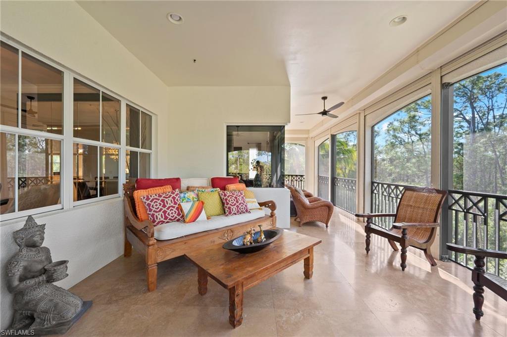 2886 Castillo Court, Unit 103 Naples, FL 34109 - Photo 16 of 38 a living room with furniture and a floor to ceiling window