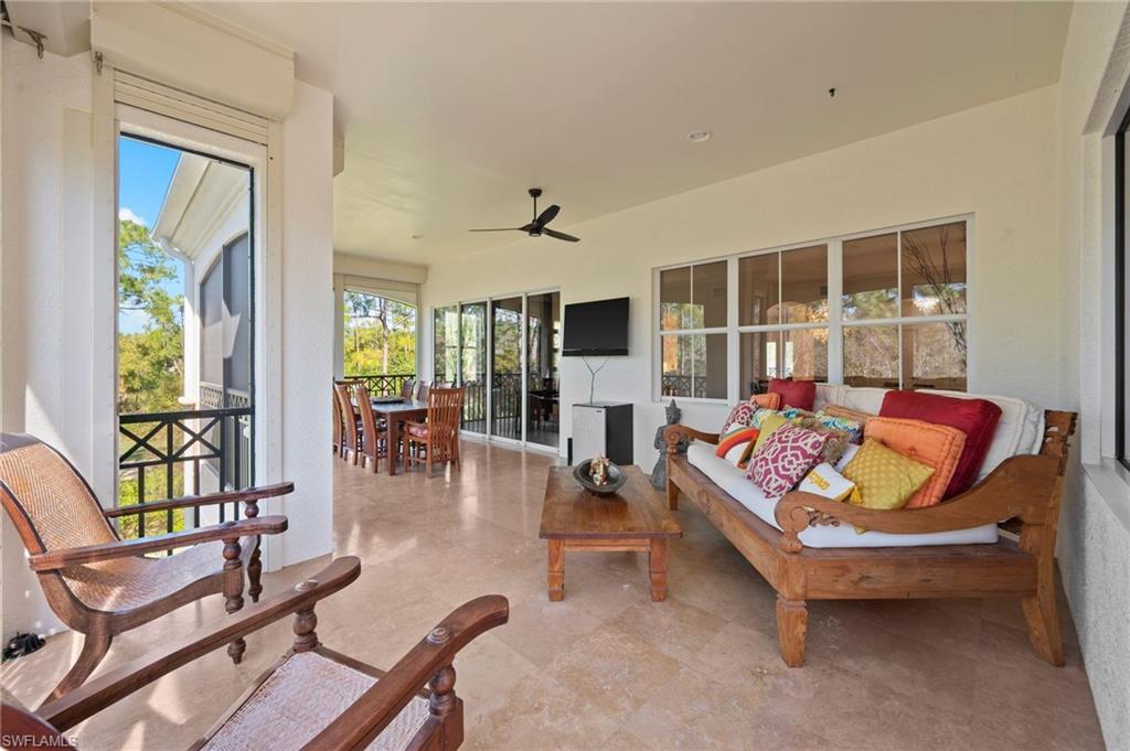 2886 Castillo Court, Unit 103 Naples, FL 34109 - Photo 17 of 38 a living room with furniture and a large window