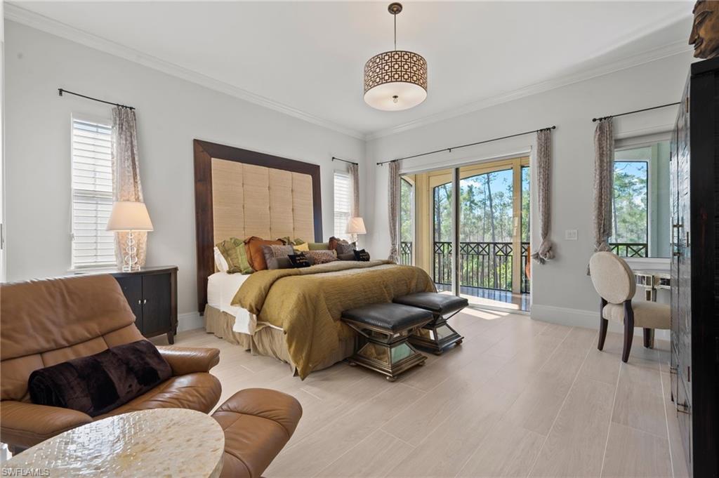 2886 Castillo Court, Unit 103 Naples, FL 34109 - Photo 20 of 38 a spacious bedroom with bed and a large window