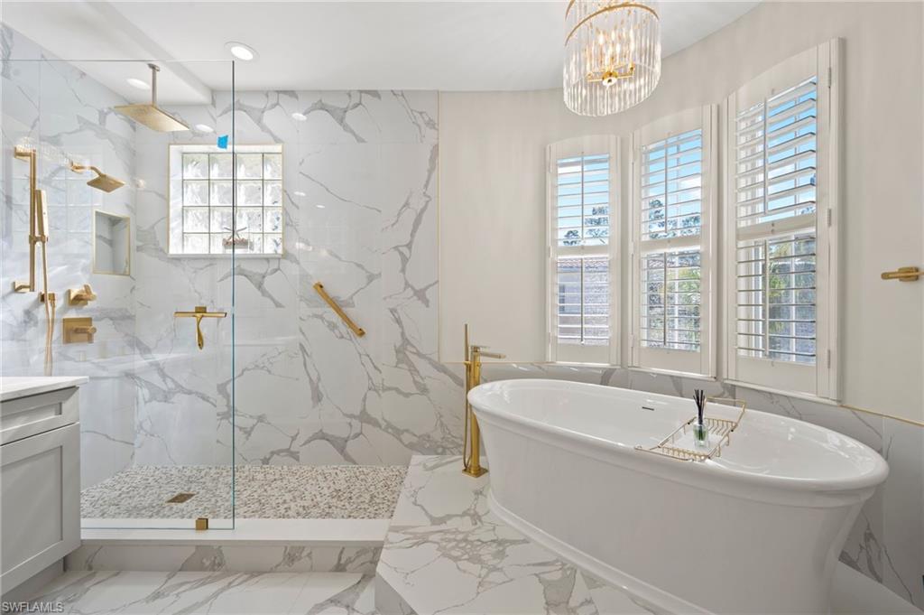 2886 Castillo Court, Unit 103 Naples, FL 34109 - Photo 24 of 38 a bath tub sitting next to a window