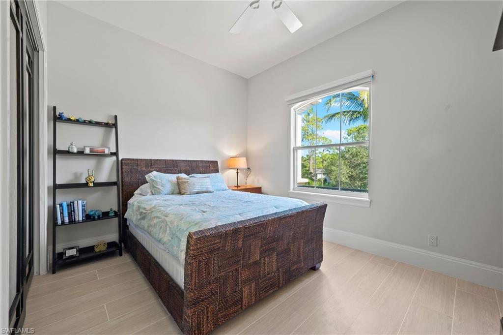 2886 Castillo Court, Unit 103 Naples, FL 34109 - Photo 25 of 38 a bedroom with a bed and window