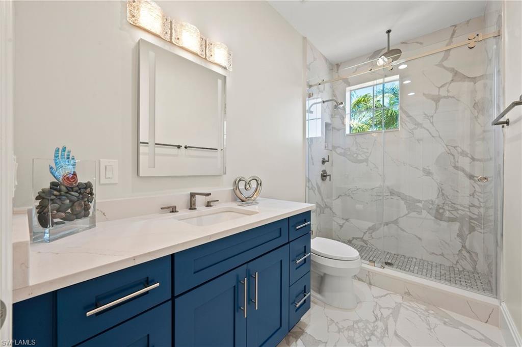 2886 Castillo Court, Unit 103 Naples, FL 34109 - Photo 26 of 38 a bathroom with a sink a toilet and shower