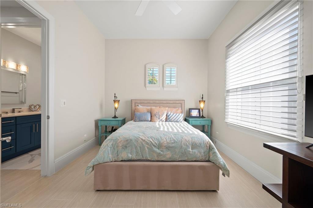 2886 Castillo Court, Unit 103 Naples, FL 34109 - Photo 27 of 38 a bedroom with a bed and a window