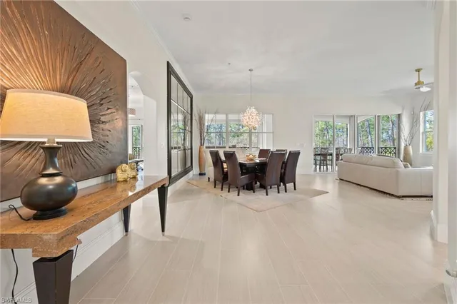 a dining room with furniture and a window