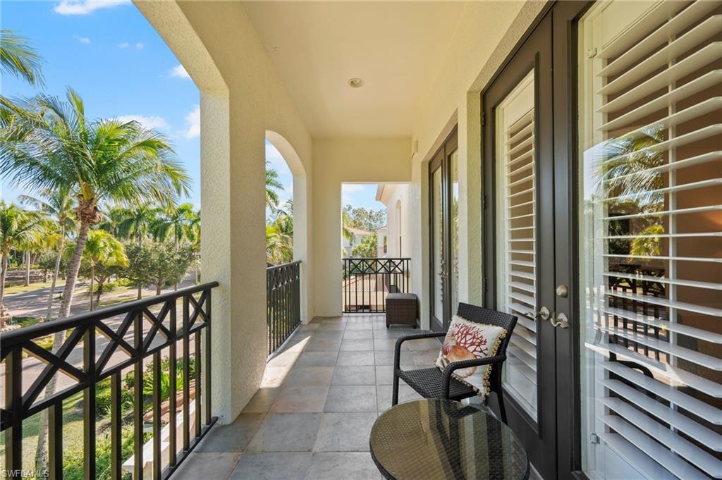 2886 Castillo Court, Unit 103 Naples, FL 34109 - Photo 8 of 38 a balcony view with a couch and table in front of it