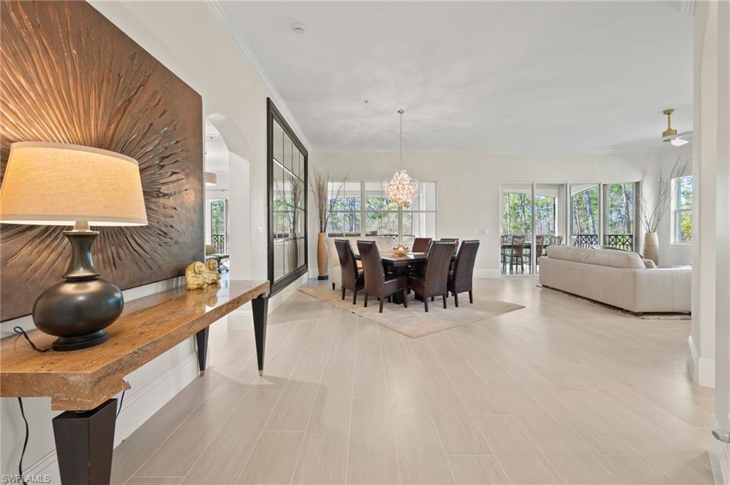 2886 Castillo Court, Unit 103 Naples, FL 34109 - Photo 10 of 38 a dining room with furniture and a window