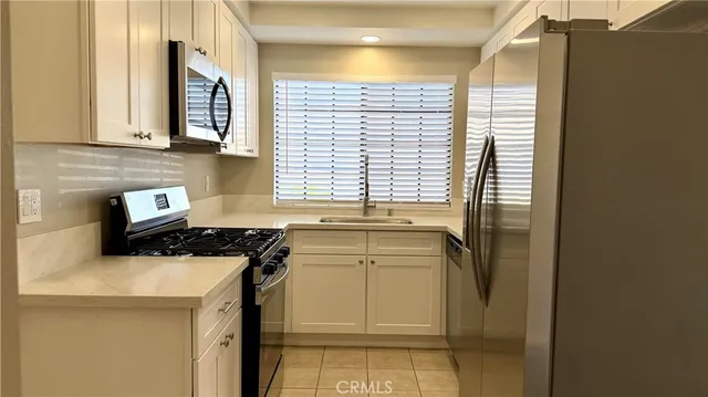 a kitchen with a stove and a white cabinet