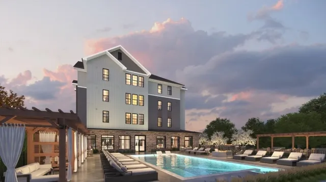 a front view of a building with outdoor space and swimming pool