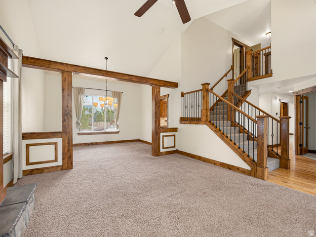 1279 West 1500th Street North Mapleton, UT 84664 - Photo 13 of 83 Vaulted ceiling living area featuring a prominent staircase with wood newel posts and iron balusters