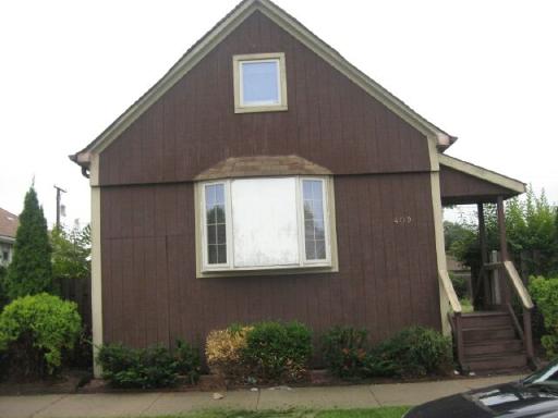 409 Pulaski Road Calumet City, IL 60409 - Photo 1 of 1 a front view of a house with a yard