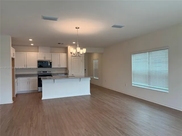 a view of kitchen with sink and microwave