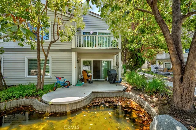 a view of a house with swimming pool and sitting area