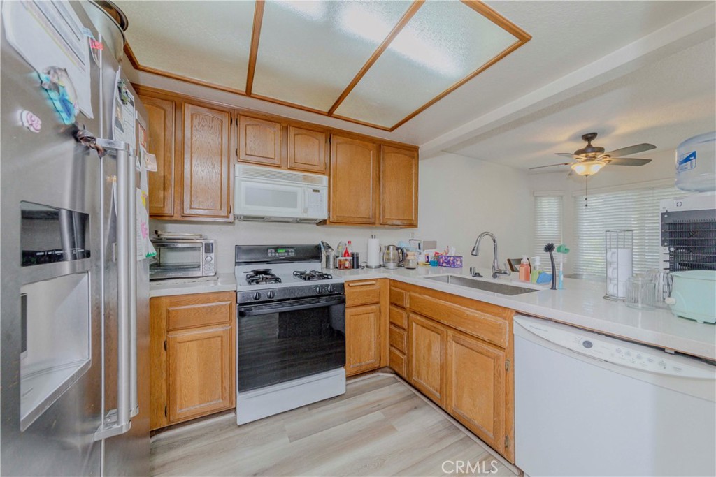 22224 South Vermont Avenue, Unit 102C Torrance, CA 90502 - Photo 11 of 27 a kitchen with stainless steel appliances granite countertop a sink and cabinets