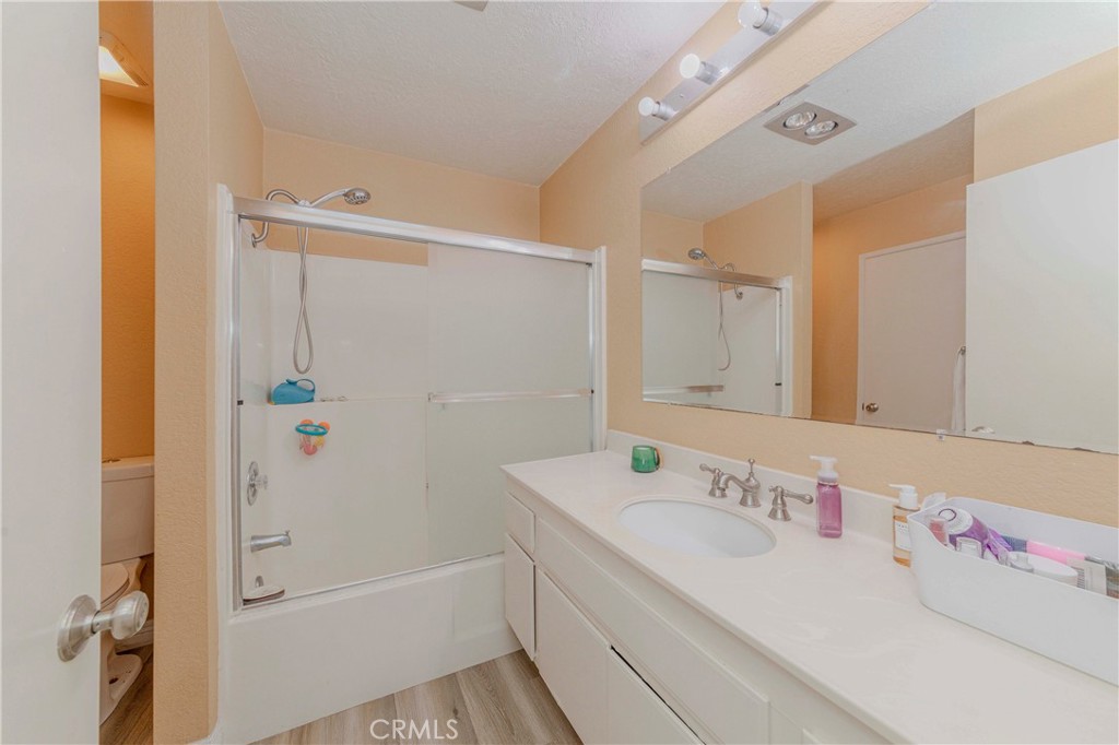22224 South Vermont Avenue, Unit 102C Torrance, CA 90502 - Photo 13 of 27 a bathroom with a granite countertop sink and a shower