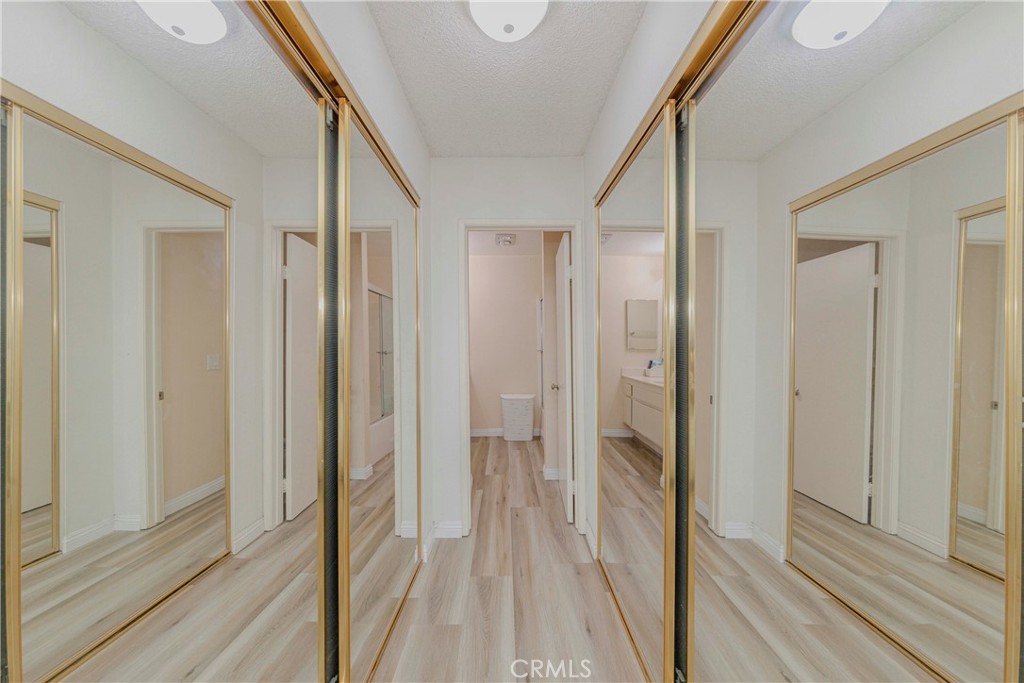 22224 South Vermont Avenue, Unit 102C Torrance, CA 90502 - Photo 16 of 27 a view of a hallway with wooden floor and staircase