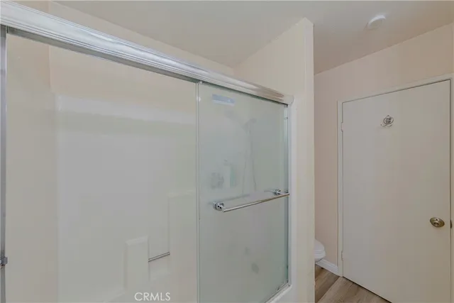 a bathroom with a glass shower door