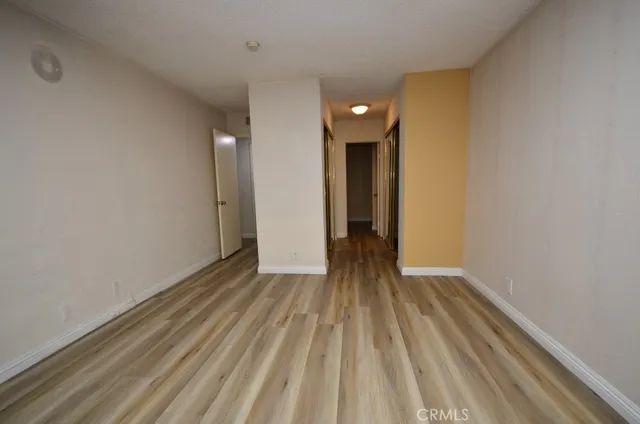 a view of an empty room and wooden floor