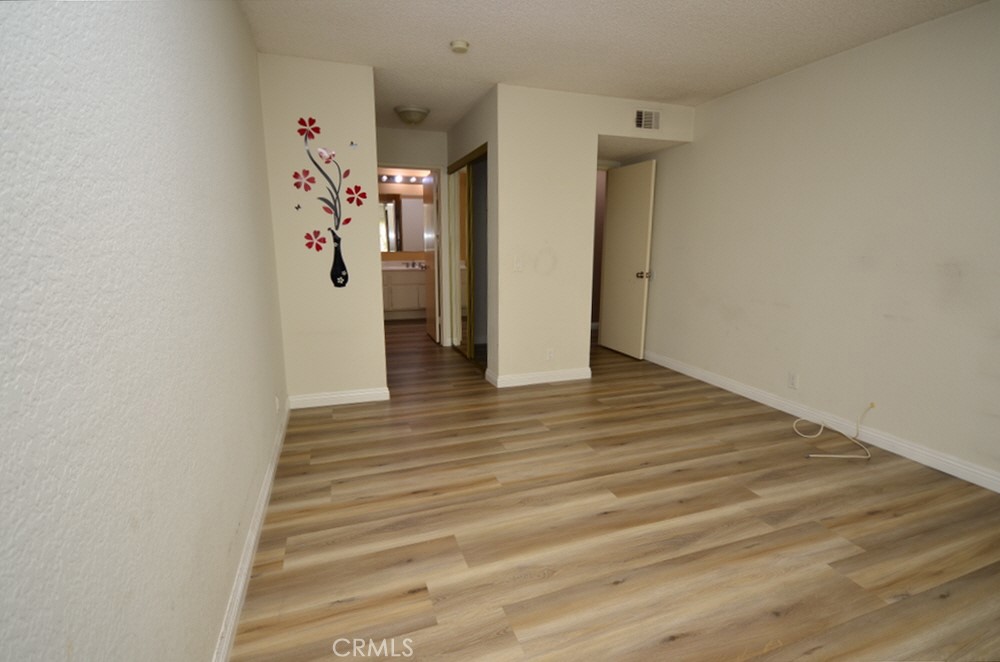 22224 South Vermont Avenue, Unit 102C Torrance, CA 90502 - Photo 21 of 27 a view of a hallway with wooden floor and entryway